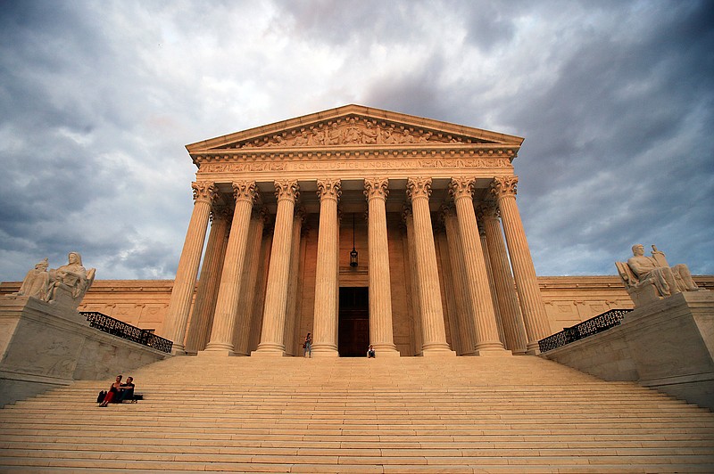 In this Oct. 18, 2018 file photo, the U.S. Supreme Court is seen at near sunset in Washington. Dozens of legal briefs supporting fired funeral director Aimee Stephens at the Supreme Court use "she" and "her" to refer to the transgender woman. So does the appeals court ruling in favor of Stephens that held that workplace discrimination against transgender people is illegal under federal civil rights law. But in more than 110 pages urging the Supreme Court to reverse that decision, the Trump administration and the funeral home where Stephens worked avoid those gender pronouns. (AP Photo/Manuel Balce Ceneta, File)