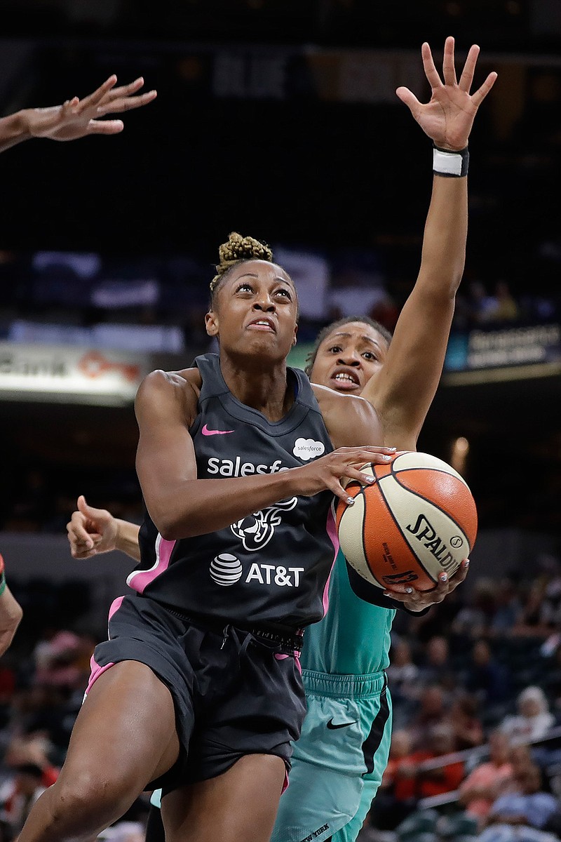 Indiana Fever's Tiffany Mitchell (3) puts up a shot against New York Liberty's Tanisha Wright (30) during the second half of a WNBA basketball game, Tuesday, Aug. 20, 2019, in Indianapolis. (AP Photo/Darron Cummings)