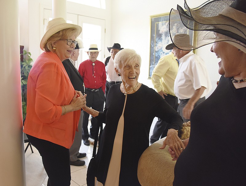 Bobbie Herman, middle, greets Mary Ann Hyleck, right, and Karen Connell on Wednesday as Barbara Kalberloh hosted a tea party at her home. The gathering was to raise money for Goldschmidt Cancer Center and for the annual Boost BBQ today.