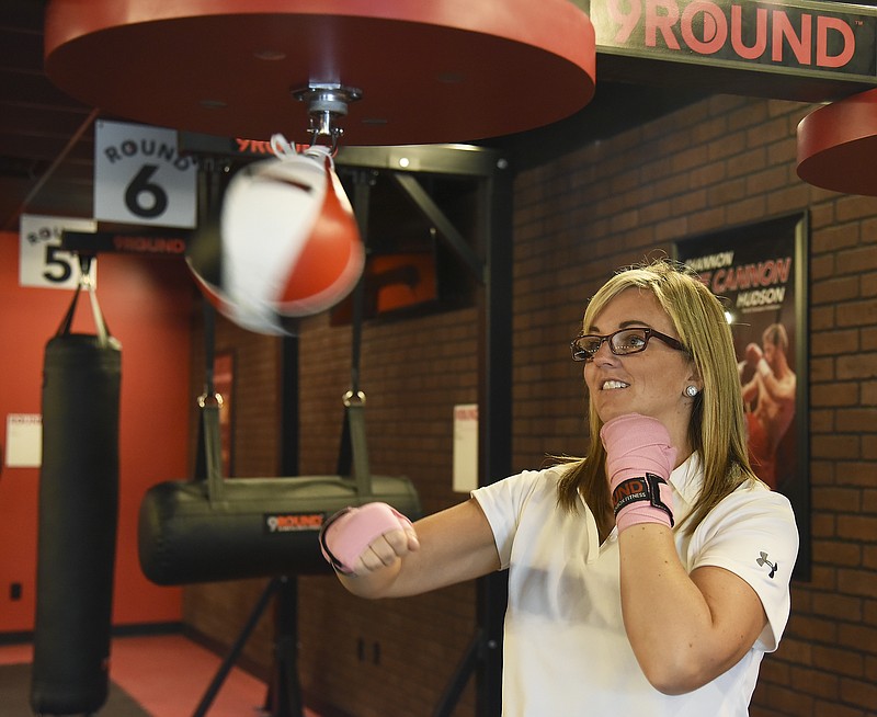 Julie Smith/News TribuneKelli Johnson, owner of 9Round Kickboxing at 1407 Southwest Boulevard, demonstrates hitting a speedbag in the new-to-Jefferson City workout facility. 