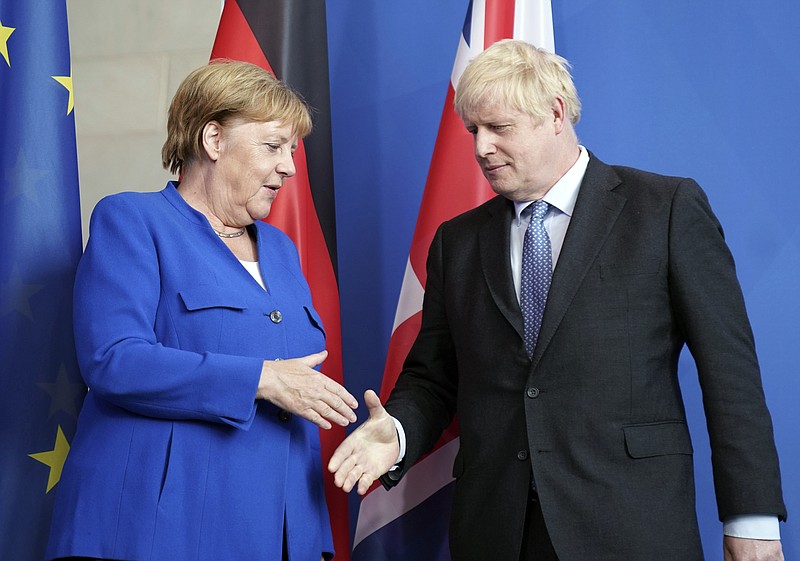 Germany's Chancellor Angela Merkel and British Prime Minister Boris Johnson attend a joint press conference, in Berlin, Wednesday, Aug. 21, 2019. German Chancellor Angela Merkel says she plans to discuss with UK Prime Minister Boris Johnson how Britain's exit from the European Union can be "as frictionless as possible." (Kay Nietfeld/dpa via AP)