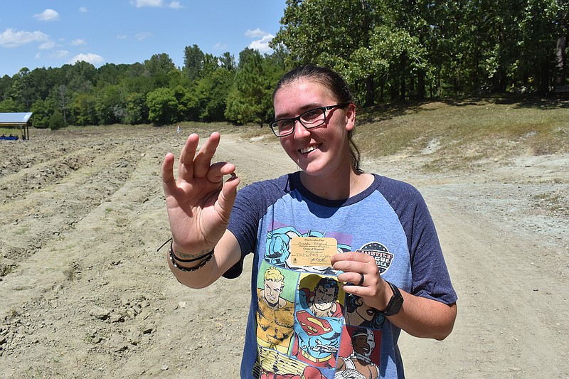 Miranda Hollingshead of Texas shows off her large yellow diamond, found this week at Crater of Diamonds State Park in Arkansas. She says she will probably put it in a ring. (Photo courtesy of Crater of Diamonds State Park)
