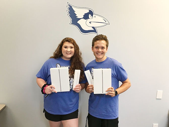 Westminster College students Payton Cooley and Barrett Houska hold their new iPads provided to them through "Digital Blue." The program provides every Westminster student and faculty member with a 9.7-inch Apple iPad tablet along with an iPad charger and Apple pencil.