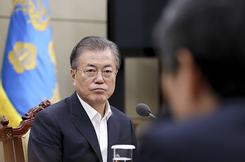 In this photo provided by South Korea Presidential Blue House, South Korean President Moon Jae-in listens a report from officials about the General Security of Military Information Agreement, or GSOMIA, at the Presidential Blue House in Seoul, South Korea, Thursday, Aug. 22, 2019.  South Korea will stop exchanging classified intelligence on North Korea with Japan amid a bitter trade dispute, an official said Thursday, a surprise announcement that is likely to set back U.S. efforts to bolster security cooperation with two of its most important allies in the Asian region. (South Korea Presidential Blue House via AP)