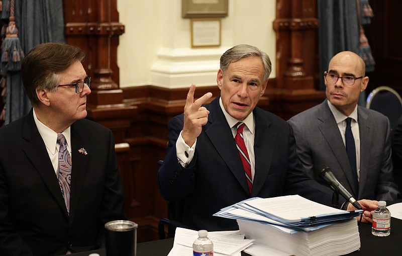 Texas Gov. Greg Abbott, center with Speaker of the House Dennis Bonnen, right, and Lt. Governor Dan Patrick, left, makes opening statements during a round table discussion, Thursday, Aug. 22, 2019, in Austin, Texas. Abbott is meeting in Austin with officials from Google, Twitter and Facebook as well as officials from the FBI and state lawmakers to discuss ways of combatting extremism in light of the recent mass shooting in El Paso that reportedly targeted Mexicans. (AP Photo/Eric Gay)