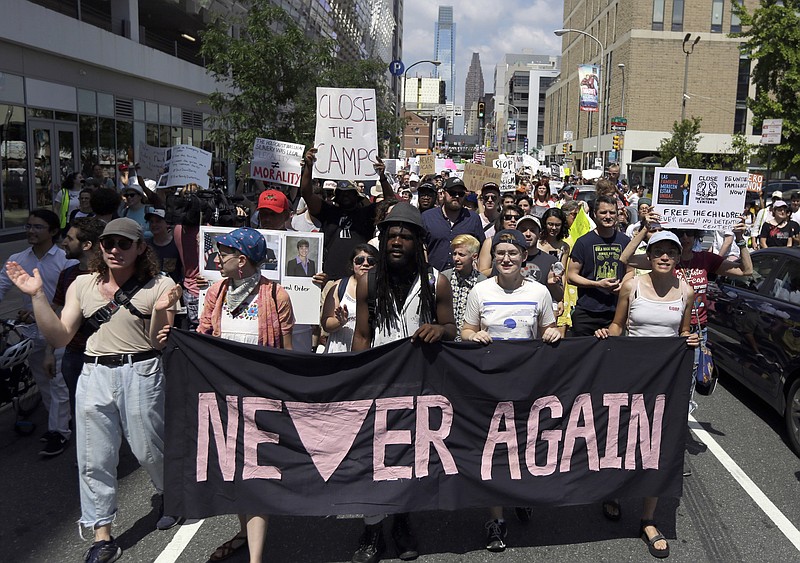 FILE - In this July 4, 2019, file photo, protesters assembled by a majority Jewish group called Never Again Is Now walk through traffic as they make their way to Independence Mall in Philadelphia. A fledgling coalition of liberal Jewish groups is increasingly making itself heard as it fights the Trump administration’s immigration policies. (AP Photo/Jacqueline Larma, File)
