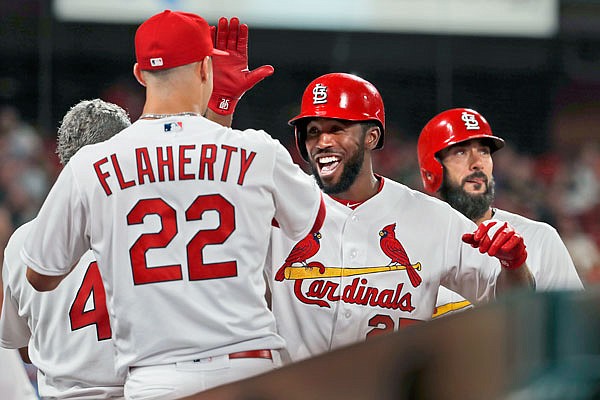 Dexter Fowler of the Cardinals is congratulated after hitting a two-run home run during the seventh inning of Thursday night's game against the Rockies at Busch Stadium.