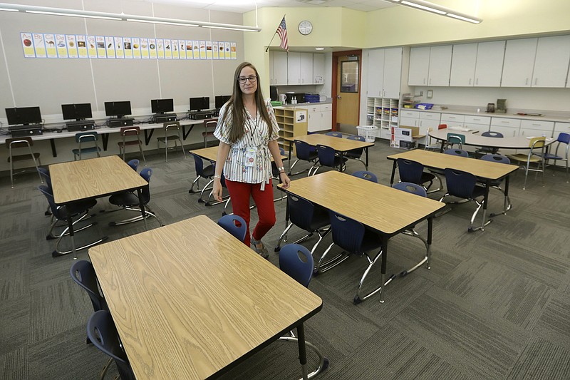 First-grade teacher Hillary Madrigal is photographed in her classroom Thursday, Aug. 22, 2019, in Salt Lake City. Across the country, teachers and school districts alike are grappling with the latest political and economic realities of educator pay. Madrigal jumped to the nearby school district last year, lured by higher salaries that would allow her to quit her second job as a housekeeper and buy a new car. "I have a college degree. I felt I could make a difference in people's lives as a teacher but to pay my bills ... I had to do people's laundry," said Madrigal, who now works for the Salt Lake City School District. (AP Photo/Rick Bowmer)