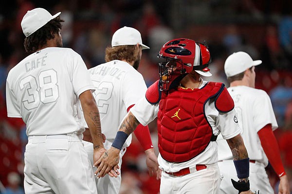 Cardinals catcher Yadier Molina and Jose Martinez celebrate after Friday night's 8-3 win against the Rockies at Busch Stadium.
