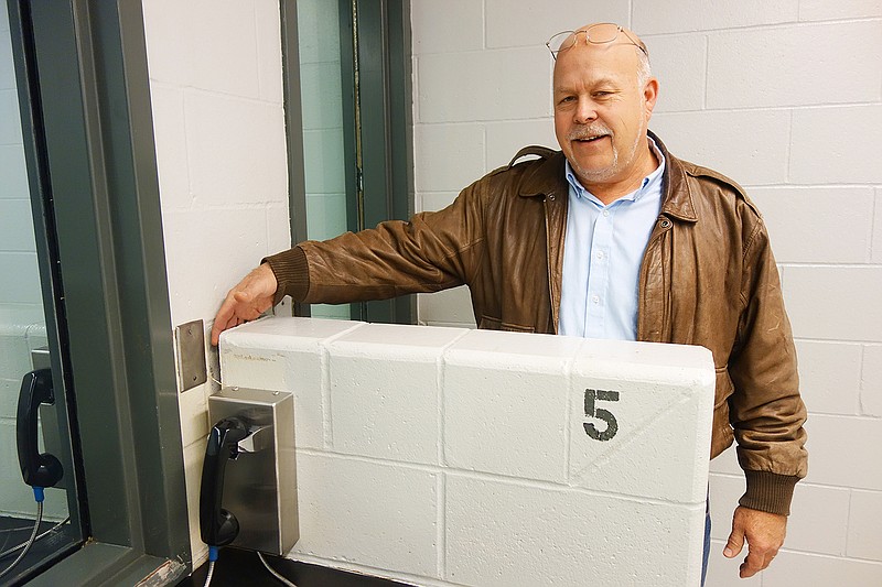 Gary Jungermann, Callaway County presiding commissioner, demonstrates the width of a crack between a partition and the wall in the Callaway County Jail's visitation room. County officials have determined a new jail and courthouse are necessary as the county grows. On Friday, they voted to put two propositions imposing new sales taxes on the ballot.
