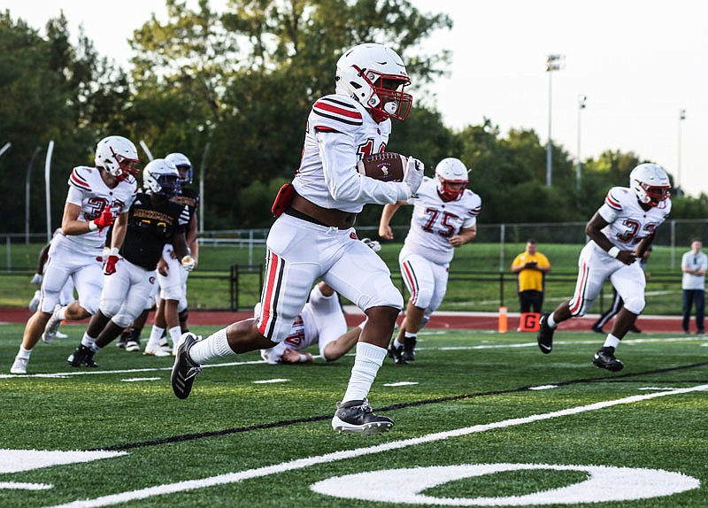 Jays defensive back Kevion Pendleton returns an interception against Hickman during Friday night's Jamboree at Rock Bridge in Columbia.