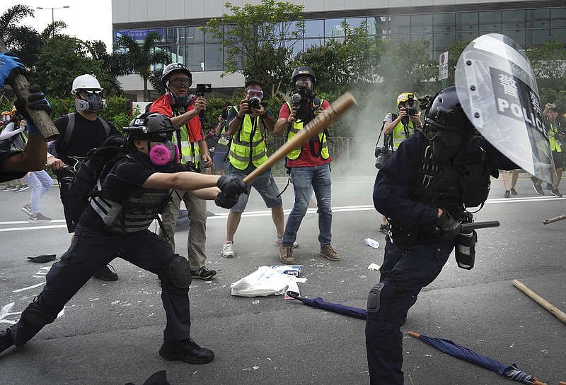 Police and demonstrators clash during a protest in Hong Kong, Saturday, Aug. 24, 2019. Chinese police said Saturday they released an employee at the British Consulate in Hong Kong as the city's pro-democracy protesters took to the streets again, this time to call for the removal of "smart lampposts" that raised fears of stepped-up surveillance. (AP Photo/Vincent Yu)
