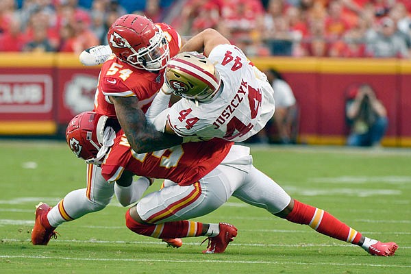 49ers fullback Kyle Juszczyk is tackled by Chiefs linebacker Damien Wilson (54) and cornerback Herb Miller during the first half of Saturday night's preseason game at Arrowhead Stadium.
