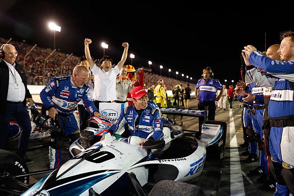 Takuma Sato prepares to climb out of his car Saturday night after winning the IndyCar Series race at World Wide Technology Raceway in Madison, Ill.