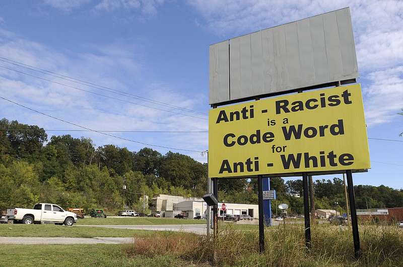FILE - In this Oct. 16, 2013 file photo, motorists drive past a newly installed billboard near the intersection of Arkmo Road and Vine Road in Harrison, Ark. The threat of white supremacy has been well known in Arkansas, where various extremist groups have made their home over the decades, but efforts to enact a hate crimes measure have been unsuccessful. The latest push comes from Republican Gov. Asa Hutchinson. (Samantha Baker/The Arkansas Democrat-Gazette via AP)