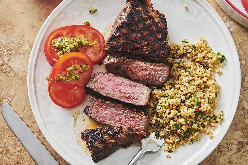 This 2019 photo shows grilled marinated New York Strip Steak in New York. Marinating is a terrific basic kitchen technique. Essentially, you can take any kind of meat, fish or seafood, submerge it in a marinade, and you've turned a plain something into a great dinner. (Cheyenne Cohen/Katie Workman via AP)