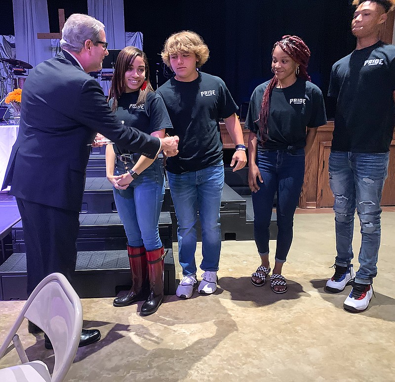Mike Ingram, board president of Harvest Regional Food Bank, shakes hands with kids from the PRIDE academy for winning an award at Williams Memorial on Tuesday, August 27, 2019, in Texarkana, Texas. Harvest Regional Food Bank kicked off Hunger Action Month with a luncheon at Williams Memorial.