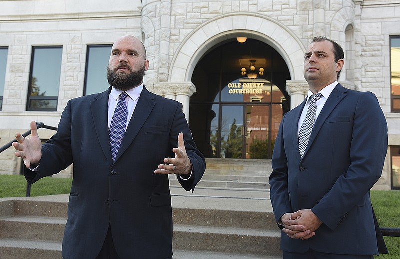 Dave Roland, left, and Patrick Ishmael address the media Wednesday morning outside the Cole County Courthouse in Jefferson City, where Roland filed a lawsuit on behalf of Ishmael and the Show-Me Institute, for which Ishmael is director of government accountability. Roland is director of litigation and co-founder of Freedom Center of Missouri.