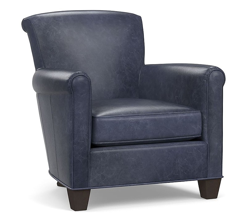 This photo shows Pottery Barn's Irving roll arm leather armchair. The Irving looks modern in on-trend indigo blue leather. (Pottery Barn via AP)