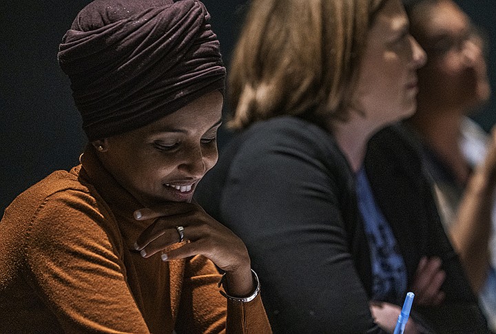 U.S. Rep. Ilhan Omar smiles during a town hall in South Minneapolis on the U.S. Immigration and Customs Enforcement agency and the administration's immigration detention policies, Tuesday, Aug. 27, 2019. (Richard Tsong-Taatarii/Star Tribune via AP)