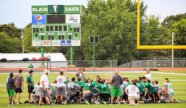 Blair Oaks head coach Ted LePage (center) talks with his team as they huddle at the end of practice last week at the Falcon Athletic Complex in Wardsville.