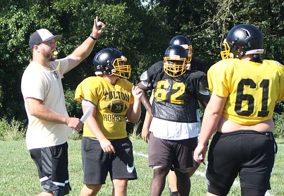 Fulton head coach Trey Barrow (left) makes an offensive play call during Tuesday's practice at the high school. The Hornets kick off the 2019 season tonight at home against School of the Osage at Robert E. Fisher Stadium.