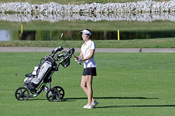 Grafton Craighead of the Lady Jays watches her shot during the Capital City Invitational last year at Meadow Lake Acres Country Club.