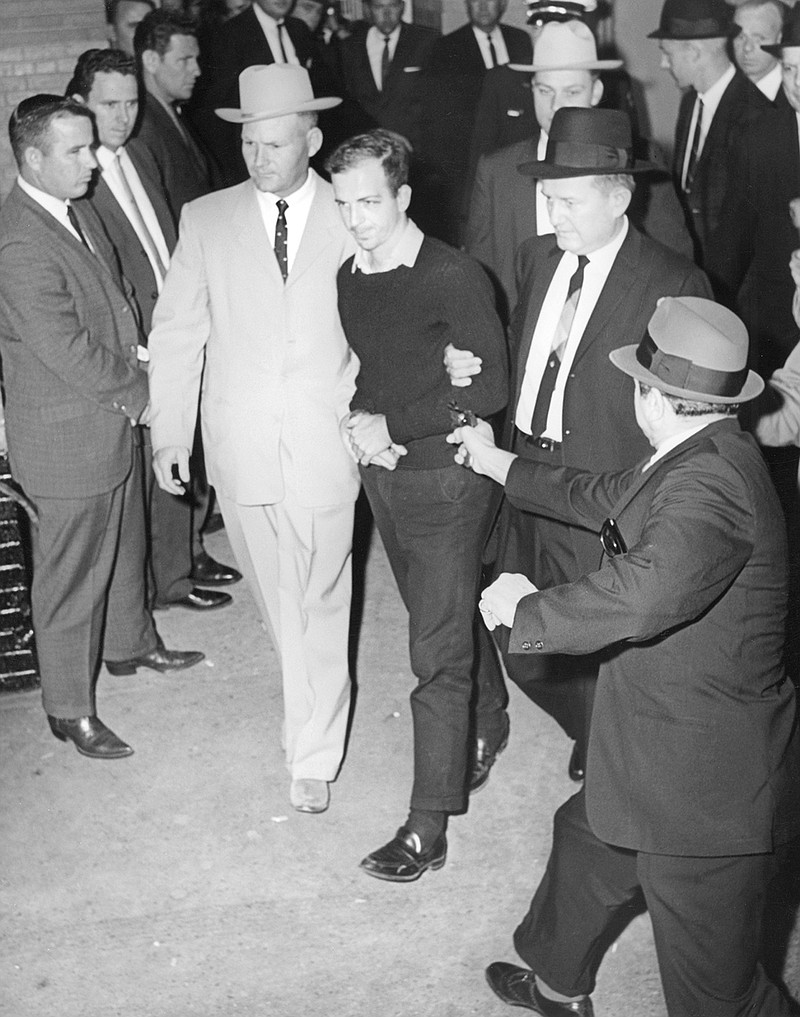 Jack Ruby, foreground, approaches and shoots Lee Harvey Oswald, center in handcuffs, as he is escorted to the Dallas city jail via the underground garage of the Dallas police headquarters, Texas, on November 24, 1963. Oswald is escorted by detectives Jim Leavelle, left, who is handcuffed to Oswald, and L.C. Graves, right. Directly behind Graves is detective L.D. Montgomery. (Jack Beers/Dallas Morning News/TNS)