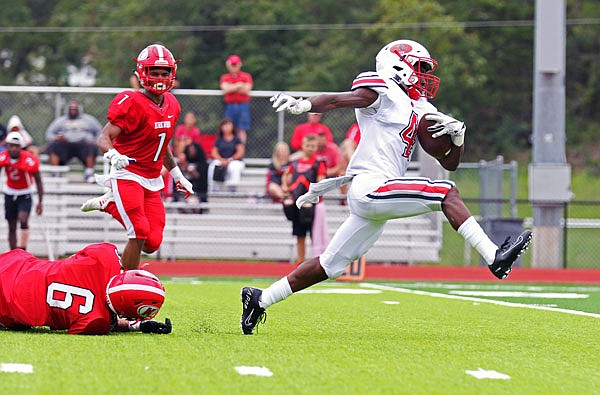 Jays running back David Bethune breaks away from Kirkwood's Jackson Fortner during a 40-yard touchdown run in the second quarter of Saturday afternoon's game at Adkins Stadium.