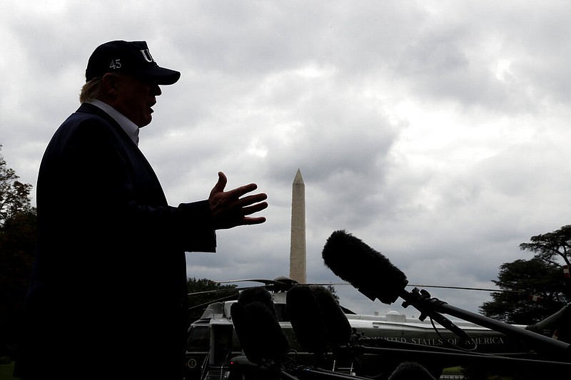 With cloudy skies in Washington, President Donald Trump speaks to the media as he returns to the White House from Camp David, Sunday, Sept. 1, 2019, in Washington. (AP Photo/Jacquelyn Martin)