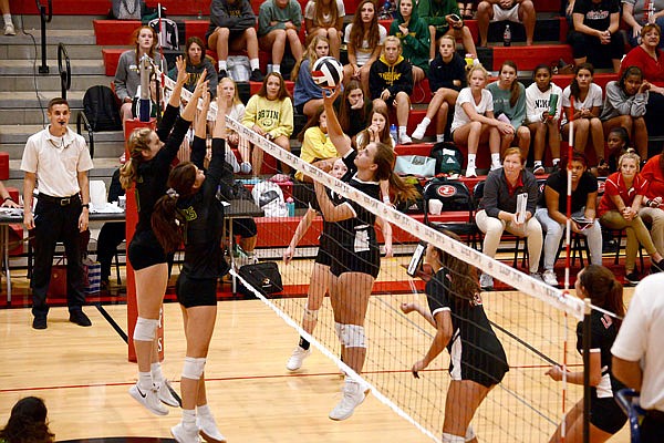 Abby Baughman of Jefferson City tips the ball over the net during Tuesday night's match against Rock Bridge at Fleming Fieldhouse.