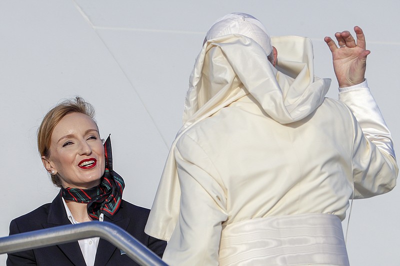 Pope Francis is greeted by a flight attendant as he boards his flight to Maputo, Mozambique, in Rome's Fiumicino International airport, Wednesday, Sept. 4, 2019. Pope Francis heads this week to the southern African nations of Mozambique, Madagascar, and Mauritius, visiting some of the world's poorest countries in a region hard hit by some of his biggest concerns: conflict, corruption, and climate change. (AP Photo/Andrew Medichini)