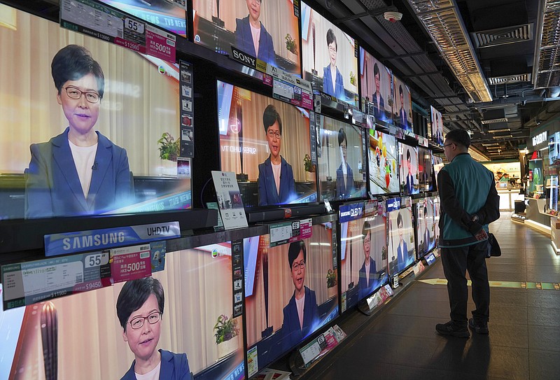 A man watches the television message that Hong Kong Chief Executive Carrie Lam makes an announcement on the extradition bill, at a home electronics retailer in Hong Kong, on Wednesday, Sept. 4, 2019. Chief Executive Lam has announced the government will formally withdraw an extradition bill that has sparked months of demonstrations in the city, bowing to one of the protesters' demands. The bill would have allowed Hong Kong residents to be sent to mainland China for trials. It sparked massive protests that have become increasingly violent and caused the airport to shut down earlier this month. (AP Photo/Vincent Yu)