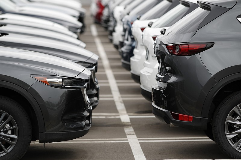 FILE - In this Sunday, May 19, 2019, file photo lines of unsold vehicles sit at a dealership in Littleton, Colo. By the 2025 model year, nearly all new vehicles sold in the U.S. will come with electronic alerts to remind people to not leave children behind in the back seats. Twenty automakers representing 98% of new vehicles sold have agreed to install reminders in an effort to stop heatstroke deaths. (AP Photo/David Zalubowski, File)