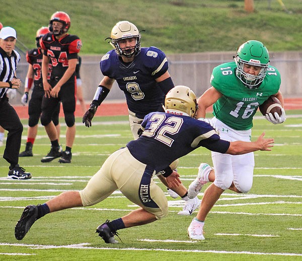 Blair Oaks wide receiver Jake Closser tries to elude a tackle from a Helias defender during last month's Jamboree at the Falcon Athletic Complex in Wardsville.