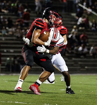 Jefferson City defensive back Devin White tackles Hannibal's Daylan Reading during Friday night's game in Hannibal.