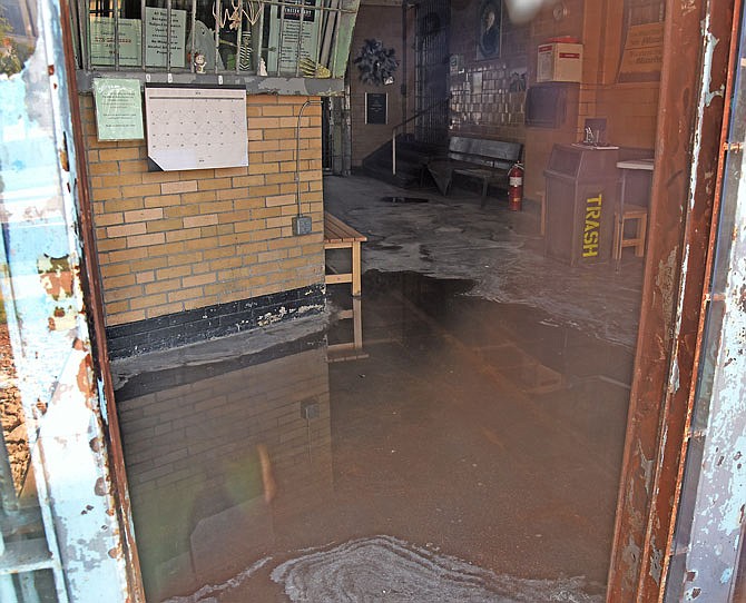 Water on the entryway floor to Housing Unit 1 is visible through the glass door at Missouri State Penitentiary. Tours are scheduled to reopen Oct. 1, under the direction of the Jefferson City Convention and Visitors Bureau.