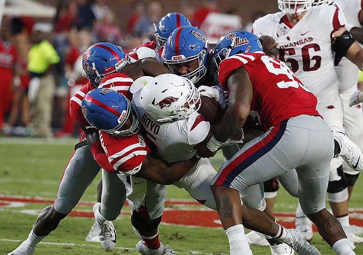 Mississippi defense tackles Arkansas running back Rakeem Boyd (5) is tackled behind the line of scrimmage during the first half of their NCAA college football game, Saturday, Sept. 7, 2019, in Oxford, Miss. (AP Photo/Rogelio V. Solis)