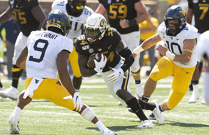 Missouri running back Larry Rountree III, center, runs between West Virginia's Jovanni Stewart, left, and Dylan Tonkery, right, during the first half of an NCAA college football game Saturday, Sept. 7, 2019, in Columbia, Mo. (AP Photo/L.G. Patterson)