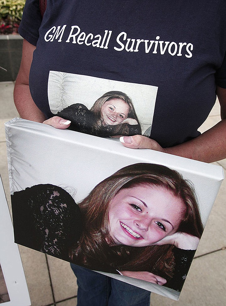 Laura Christian of Harwood, Maryland, holds a picture of her daughter 16-year-old daughter Amber Marie Rose, who was killed on July 29, 2005 in a Chevy Cobalt with a defective ignition switch, while protesting in front of the General Motors world headquarters during the GM 2014 Annual Shareholders meeting June 10, 2014 in Detroit, Michigan. (Bill Pugliano/Getty Images/TNS) *FOR USE WITH THIS STORY ONLY*