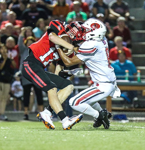 Hannibal's John Clubine intercepts a pass intended for Jefferson City's Darrell Jones during Friday night's game in Hannibal.