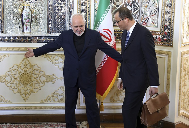 Iranian Foreign Minister Mohammad Javad Zarif, left, welcomes Acting Director-General of the International Atomic Energy Agency, IAEA, Cornel Feruta for their meeting in Tehran, Iran, Sunday, Sept. 8, 2019. (AP Photo/Vahid Salemi)
