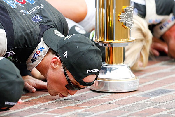 Kevin Harvick kisses the yard of bricks on the finish line Sunday after winning the Brickyard 400 at Indianapolis Motor Speedway in Indianapolis.