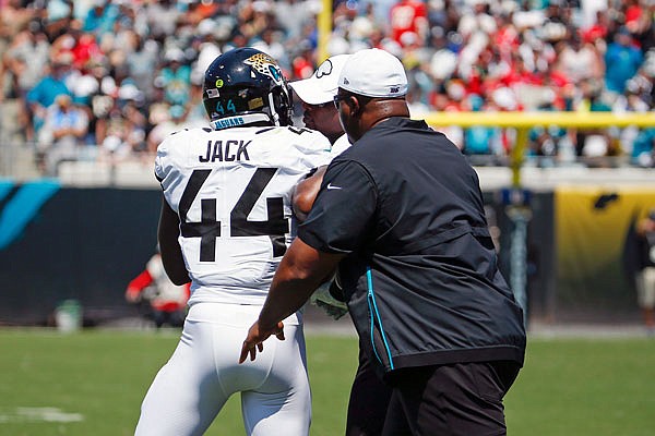 Jaguars middle linebacker Myles Jack is restrained by coaches as he tries to go back on the field after being ejected during Sunday's game against the Chiefs in Jacksonville, Fla.