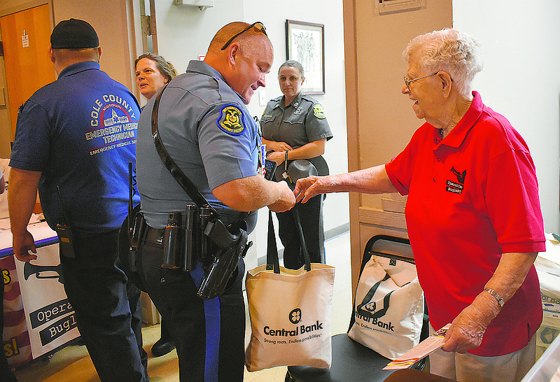 Carolyn Scheperle, right, hands a gift bag to Rick Dowd, a trooper with the Missouri Highway Patrol's Troop F, at Patriot Sunday at American Legion Post 5.