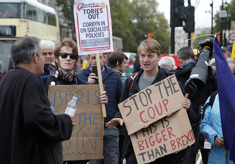 Protestors argue in parliament square in London, Monday, Sept. 9, 2019. British Prime Minister Boris Johnson voiced optimism Monday that a new Brexit deal can be reached so Britain leaves the European Union by Oct. 31.(AP Photo/Frank Augstein)