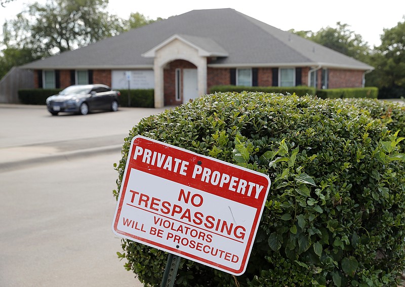 A "no trespassing" sign sits near the entrance of the parking lot for the Whole Woman's Health clinic in Fort Worth, Texas, Wednesday, Sept. 4, 2019. Faced with drives of four hours or more to Fort Worth, Dallas, El Paso or out-of-state clinics, many women in West Texas and the Panhandle need at least two days to obtain an abortion _ a situation that advocates say exacerbates the challenges of arranging child care, taking time off work and finding lodging. Some end up sleeping in their cars. (AP Photo/Tony Gutierrez)