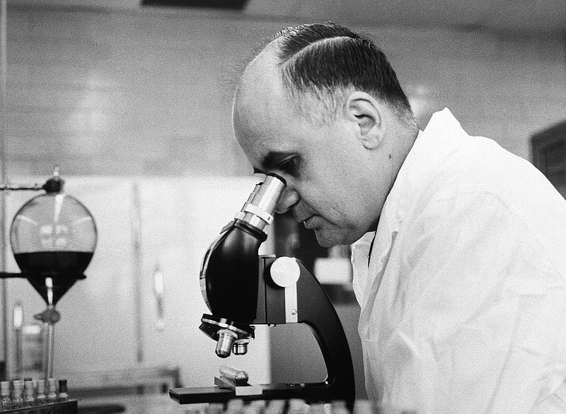 In this March 7, 1963, file photo, Dr. Maurice Hilleman, Director of virus and cell biology research, Merck Institute of Therapeutic research at West Point, checks the growth of a virus in roller tube tissue culture in Pennsylvania. Montana State University is celebrating what would have been the 100th birthday of the scientist credited with saving millions of lives through the development of vaccines against measles, mumps and other diseases. Maurice Hilleman was born in Miles City in 1919, graduated from MSU in 1941 and died in 2005. The first Hilleman scholars are set to graduate from MSU this year. (AP Photo/file)