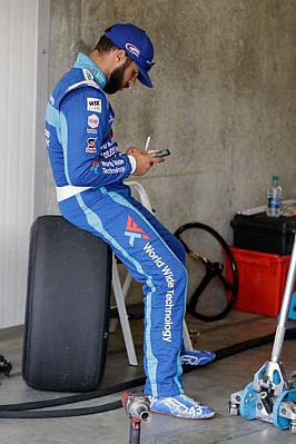 Bubba Wallace takes a break before practice Saturday at the Indianapolis Motor Speedway in Indianapolis.