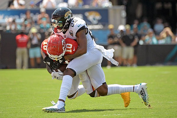 Chiefs wide receiver Tyreek Hill is stopped by Jaguars cornerback Jalen Ramsey after a reception during the first half of Sunday afternoon's game in Jacksonville, Fla.